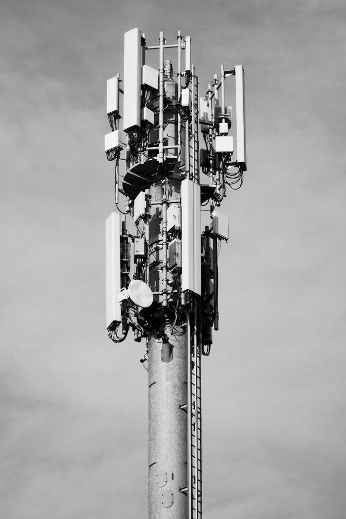 Services High-angle view of a telecommunication tower against the sky, showcasing modern infrastructure.