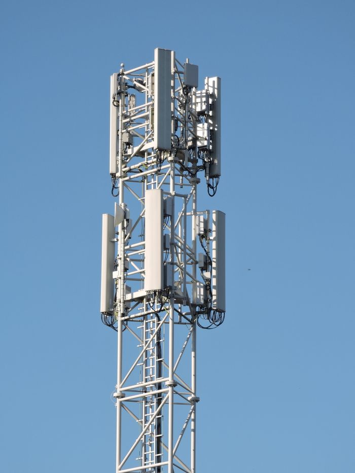Services Close-up of a communication tower with antennas against a clear blue sky, emphasizing modern technology.